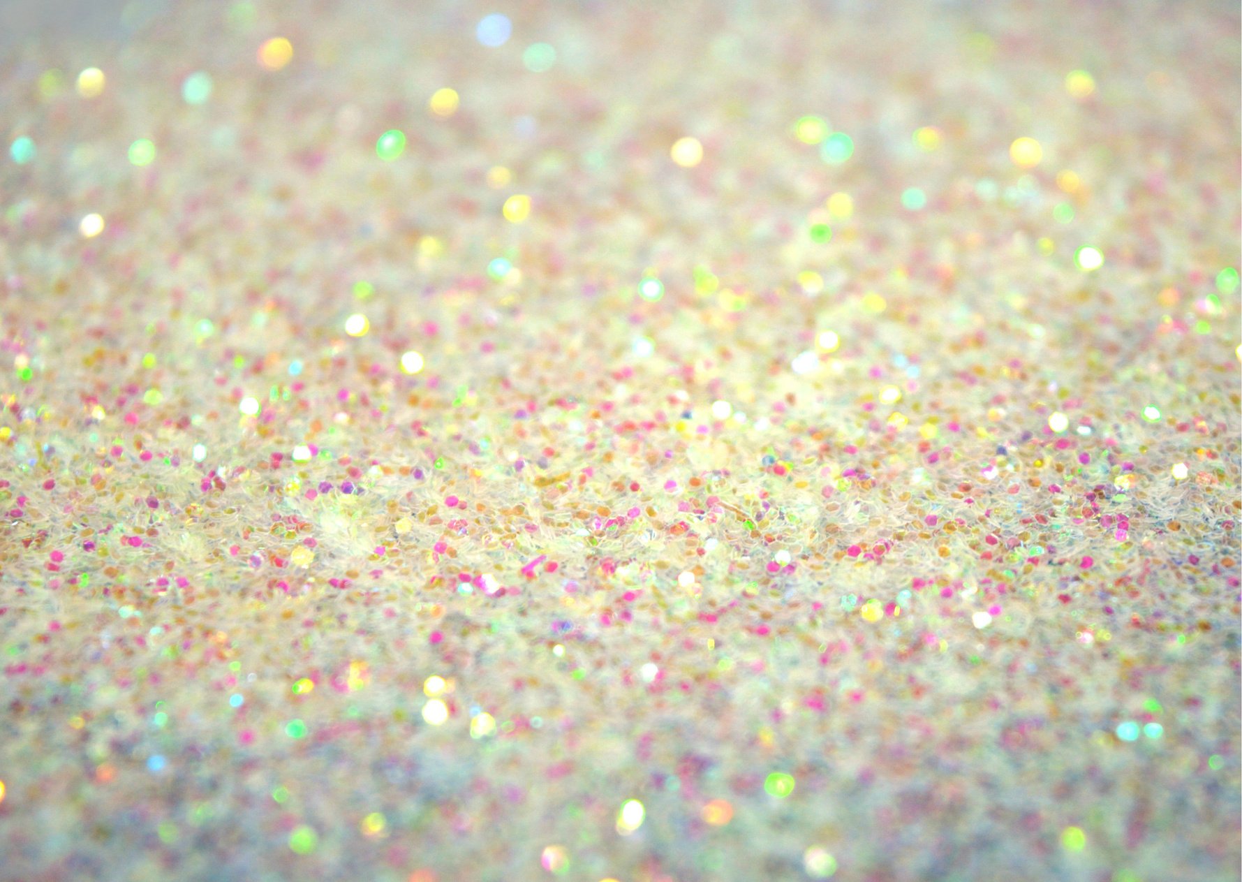 Blurred holiday background with white glitter sparkles